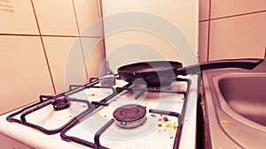 Dirty grubby gas stove in kitchen