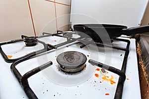 Dirty grubby gas stove in kitchen