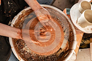 Dirty hand. Craftsman hands making pottery bowl. Woman working on potter wheel . Family business shop sculpts pot from