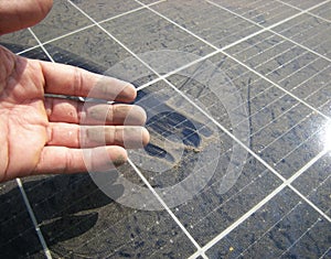 Dirty Hand after Rubbing Dusty Solar Panel