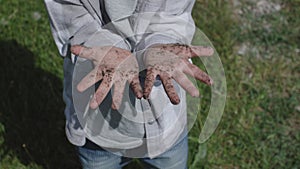 dirty hands child concept. kid shows camera dirty unwashed palms fingers summer