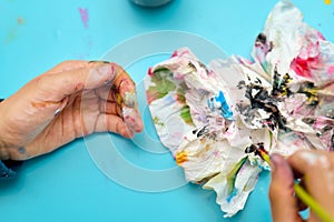 Dirty hands of a child after a watercolor painting session