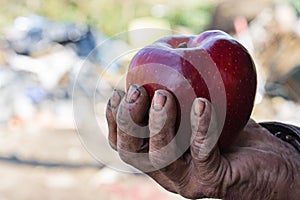 Dirty hands and fresh apple