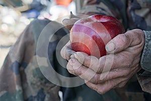 Dirty hands and fresh apple