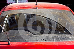 The dirty hatchback car rear window.