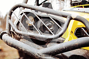 Dirty headlamps ATV in the woods