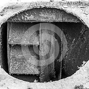 Dirty impeller of a low pressure centrifugal fan in a large supply and exhaust system, the foreground and background are blurred w