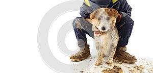 DIRTY  JACK RUSSELL DOG AND LITTLE BOY CHILD.  AFTER PLAY IN A MUD PUDDLE. ISOLATED SHOT AGAINST WHITE BACKGROUND