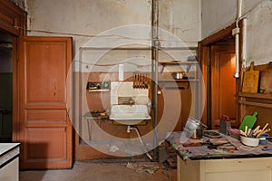 Dirty kitchen with furniture and gas stoves is in the apartment for temporary living existence refugees who were forced to mig