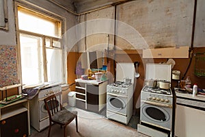 Dirty kitchen with furniture and gas stoves is in the apartment for temporary living existence refugees who were forced to mig