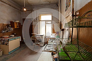 Dirty kitchen with furniture and gas stoves is in the apartment for temporary living existence refugees who were forced to mig