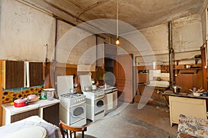 Dirty kitchen with furniture and gas stoves is in the apartment for temporary living existence refugees who were forced to mig