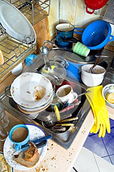 Dirty kitchen unwashed dishes photo