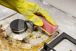 dirty kitchen stove, empty and full bottles of detergents around.