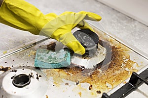 dirty kitchen stove, empty and full bottles of detergents around.