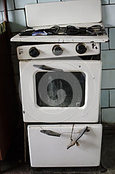 Dirty kitchen. Unsanitary conditions. Old gas stove in emergen photo