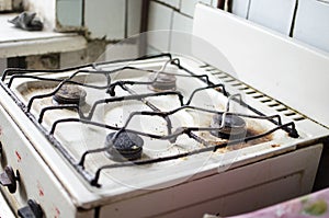 Dirty kitchen. Unsanitary conditions. Old gas stove in emergen photo