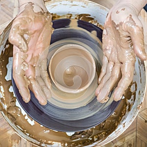 Dirty Male Potter Hands Moulding Jar on Potter`s Wheel