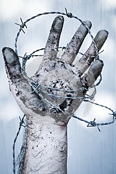 Dirty Man hand in barb wire concept for human rights