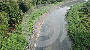 Dirty mud flow at river after widening.