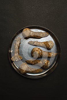 Dirty mushroom in a plate on a black background