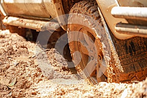 Dirty offroad car, SUV covered with mud on countryside road, Off-road tires, offroad travel and driving concept