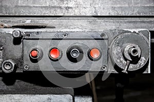 Dirty and old control panel with red buttons system for industrial machine use in the factory