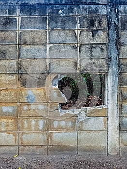 Dirty old eroded cracked plaster cement block fence. Concrete block wall. Destroyed crumbling cement mortar texture. Background of