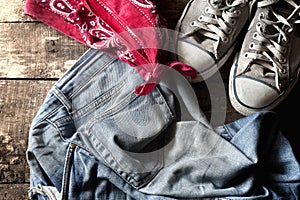 Dirty old jeans. sneakers and bandanna photo