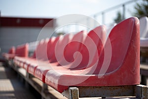 Dirty old red seats in an open-air sports stadium