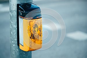 Dirty old traffic light push button on pedestrian crossing