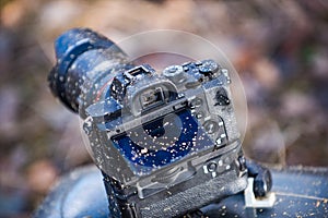 A dirty photo camera lens isolated on nature. Macro. Dustproof moisture protection. Close up dust and dirt on a camera