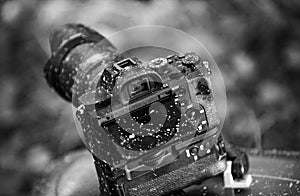 A dirty photo camera lens isolated on nature. Macro. Dustproof moisture protection. Close up dust and dirt on a camera
