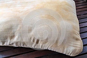 Dirty pillow on wooden table.