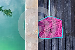 Dirty in pink net from swimming pool, pool maintenance and service during summer season