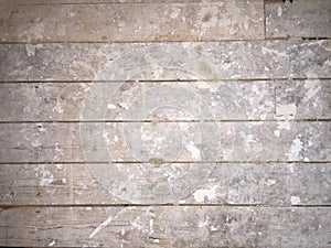 Dirty plaster covered floorboards