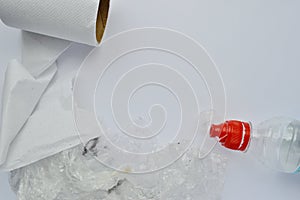 Dirty plastic bag, batteries and toilet paper on a white background