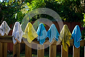 Dirty rags hanging on fence photo