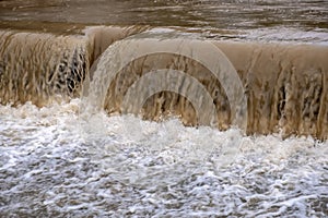 Dirty river current after rain. Mudslide concept. River flow with dirty water after heawy rain.