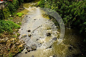 Dirty river flow photo taken in Bogor Indonesia photo