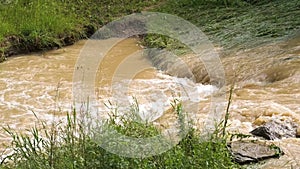 Dirty river with muddy water in flooding period during heavy rains in spring.