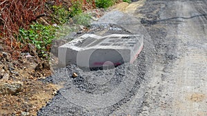 Dirty road under construction and drain pipe