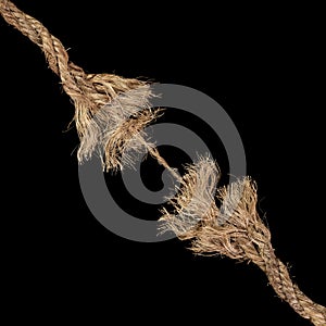 Dirty rope, frayed at both ends and ready to break apart with rope held together by a last strand ready to snap. Concept of