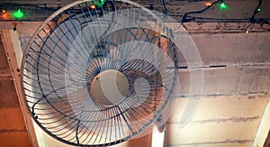 Dirty Rotational Fan on a Old Wooden Ceiling photo