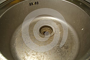 Dirty round stainless steel kitchen sink. Sloppy, ungroomed. Poor housekeeping photo