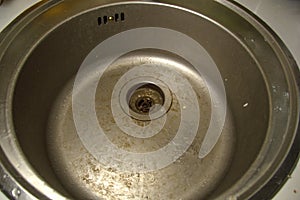 Dirty round stainless steel kitchen sink. Sloppy, ungroomed. Poor housekeeping photo