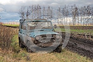 Dirty Russian car-terrain jeep UAZ-469 in the Russian field after jeeping off ro