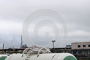 Dirty rusty cylindrical iron metal railroad tank cars capacious cars for the train on the railway at the industrial plant