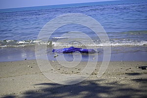 Dirty sea sandy shore the Sea. Environmental pollution. Ecological problem - Pollutions and garbages on the beach