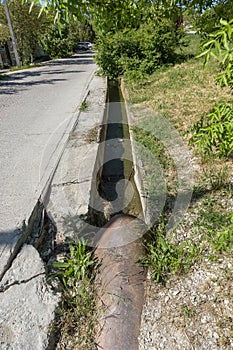 Dirty sewage and household rubbish in small river, irrigation channel causes rapid growth of algae. Water pollution. Ecological pr